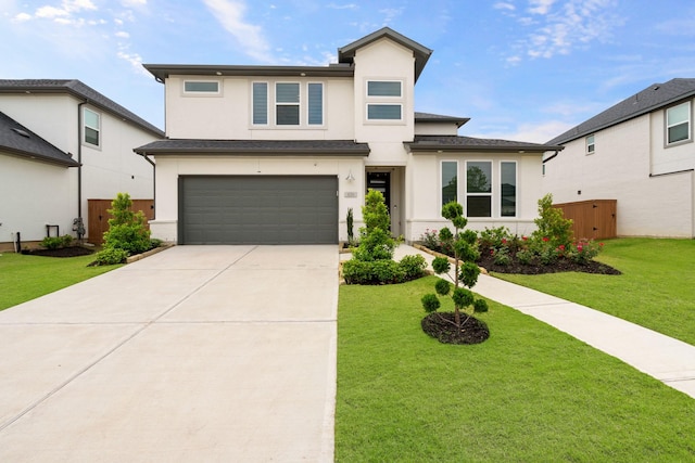 view of front of home featuring a garage and a front lawn