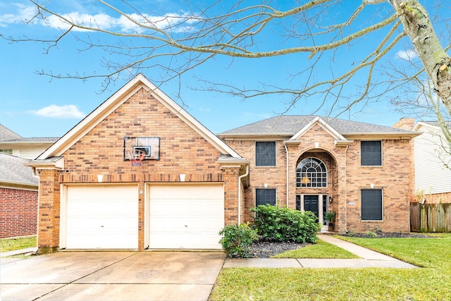 view of property featuring a garage and a front yard