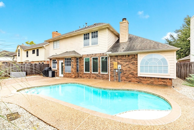 view of swimming pool featuring grilling area and a patio area