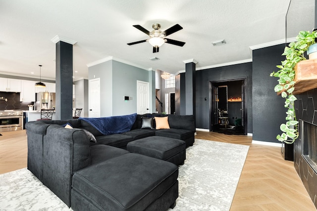 living room with light parquet floors, ornamental molding, a textured ceiling, and ceiling fan