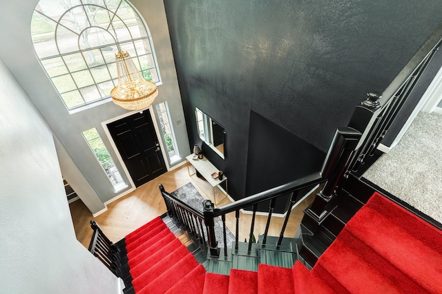 foyer featuring hardwood / wood-style flooring and a high ceiling