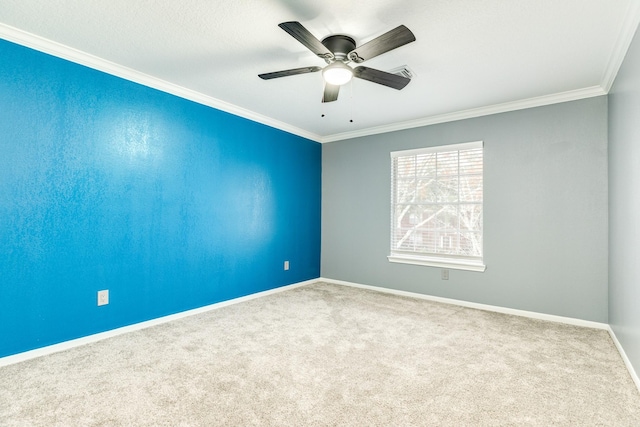 spare room with crown molding, carpet floors, and ceiling fan