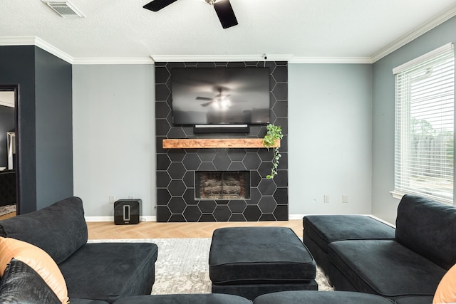 living room featuring parquet floors, a fireplace, and crown molding