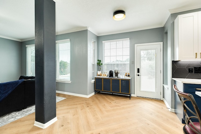 foyer with light parquet flooring and ornamental molding