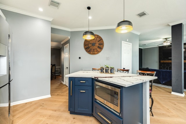 kitchen with pendant lighting, blue cabinetry, light parquet floors, stainless steel microwave, and a kitchen bar