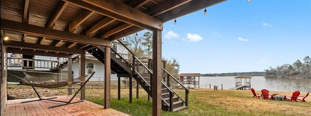 exterior space featuring a lawn and a water view