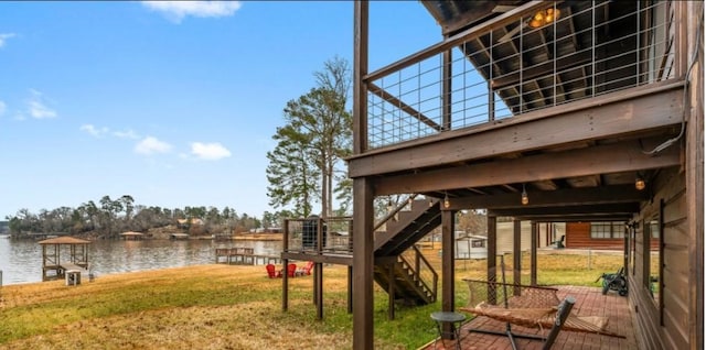 view of yard featuring a dock and a water view