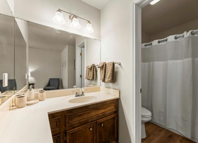 bathroom with vanity, hardwood / wood-style floors, and toilet