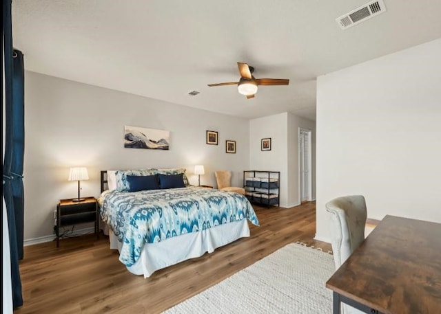 bedroom featuring dark hardwood / wood-style flooring and ceiling fan