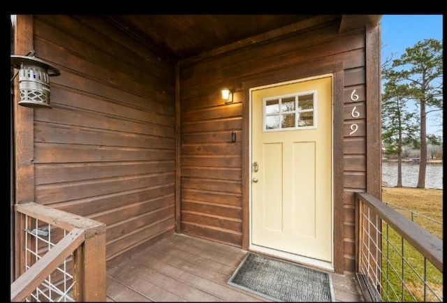 doorway to property with a water view