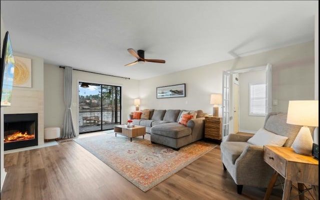 living room featuring hardwood / wood-style floors and ceiling fan