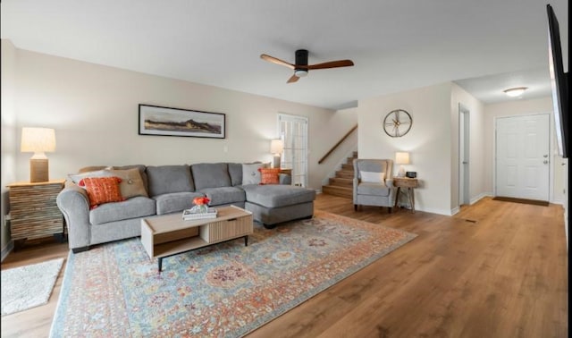 living room with ceiling fan and light hardwood / wood-style flooring