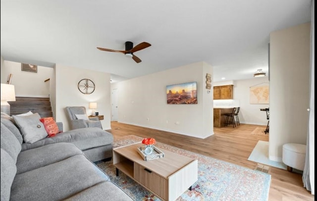 living room with ceiling fan and light wood-type flooring