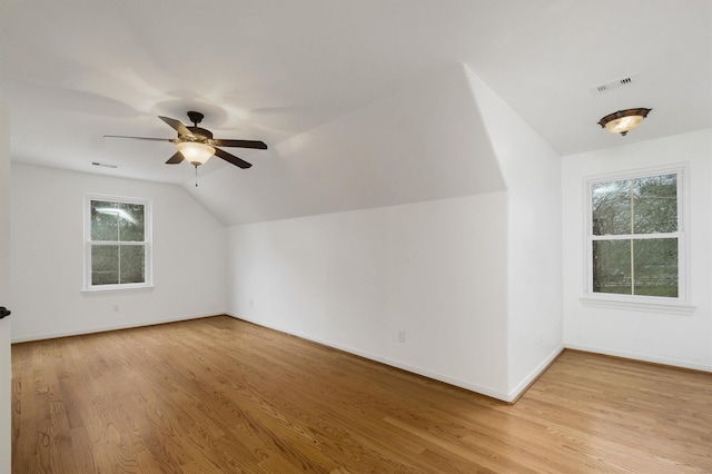 bonus room featuring lofted ceiling, light hardwood / wood-style floors, and ceiling fan