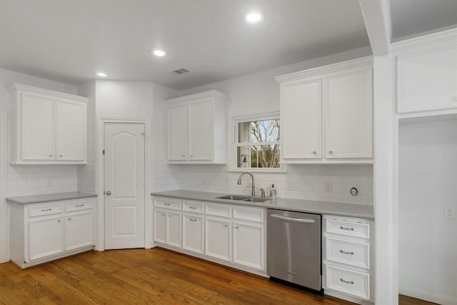 kitchen with wood-type flooring, dishwasher, sink, and white cabinets