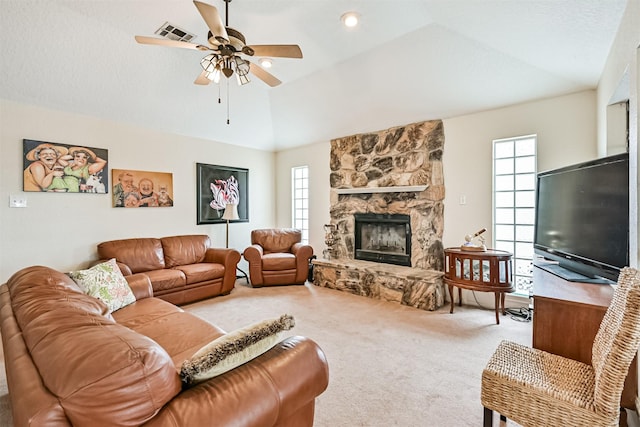 carpeted living room featuring a fireplace, a wealth of natural light, ceiling fan, and vaulted ceiling