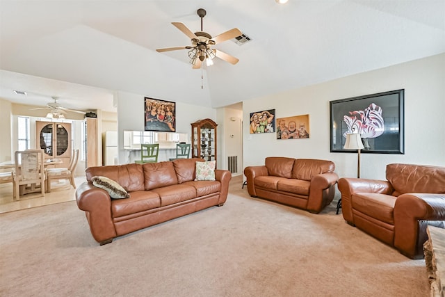 living room with ceiling fan, light colored carpet, and lofted ceiling