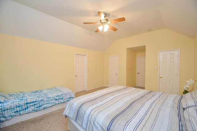 carpeted bedroom with vaulted ceiling and ceiling fan