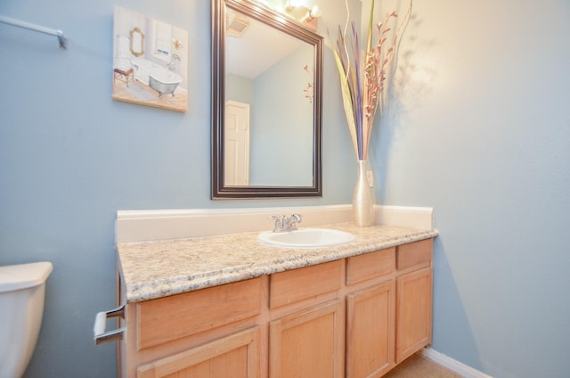 bathroom with vanity and toilet