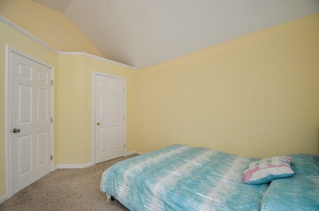 carpeted bedroom with vaulted ceiling