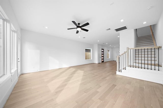 unfurnished living room with ceiling fan and light wood-type flooring