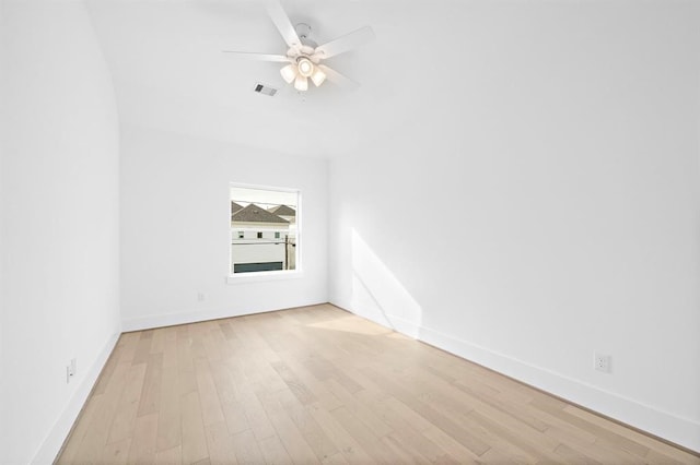 empty room with ceiling fan and light hardwood / wood-style flooring