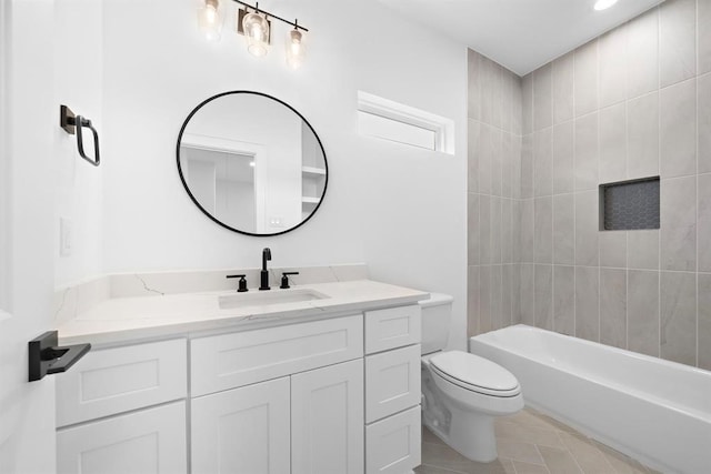 full bathroom with tile patterned floors, vanity, toilet, and tiled shower / bath combo