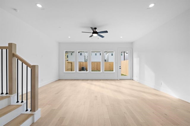 unfurnished living room with ceiling fan and light wood-type flooring