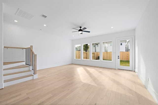 unfurnished living room with ceiling fan and light hardwood / wood-style floors