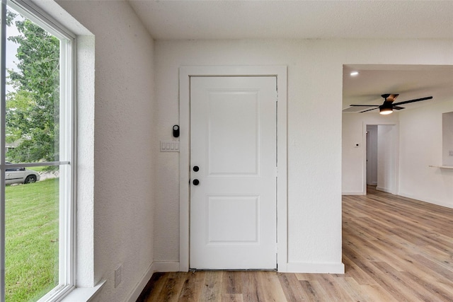 interior space with ceiling fan and light hardwood / wood-style flooring