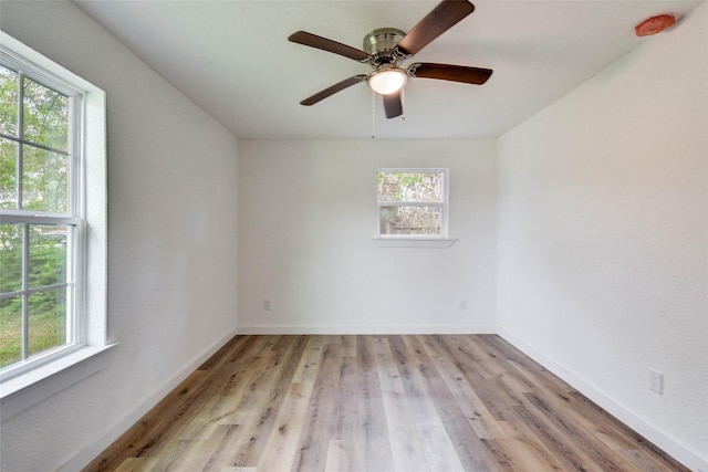 spare room with light hardwood / wood-style flooring and ceiling fan