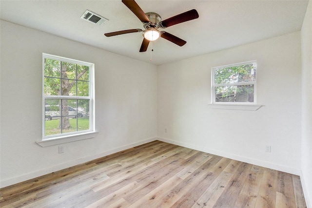 unfurnished room with ceiling fan, light hardwood / wood-style flooring, and a wealth of natural light