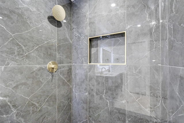 bathroom with a tile shower