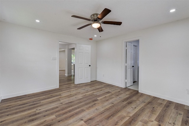 unfurnished bedroom featuring ceiling fan and hardwood / wood-style floors