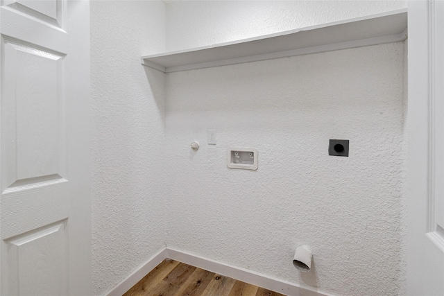 washroom with hookup for a gas dryer, wood-type flooring, and hookup for an electric dryer