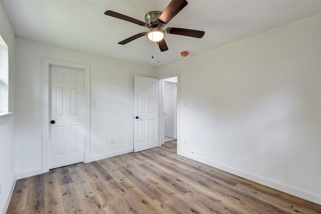 unfurnished bedroom featuring ceiling fan and light hardwood / wood-style flooring