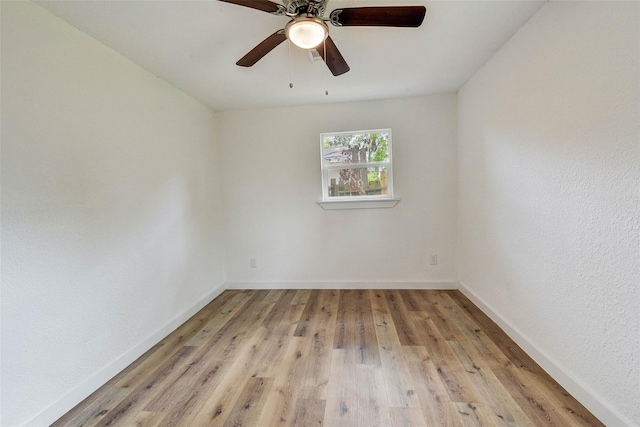 spare room featuring ceiling fan and light wood-type flooring