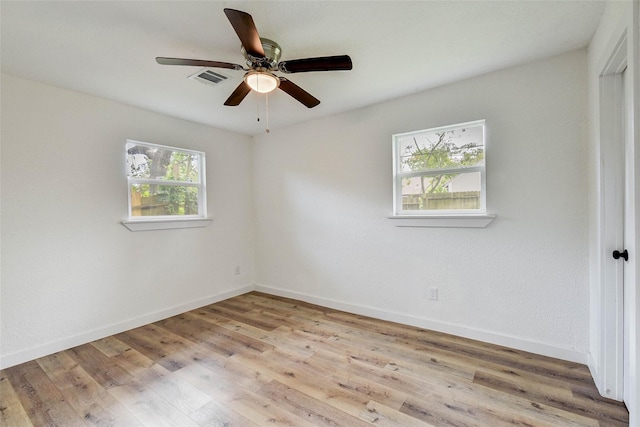 unfurnished room with ceiling fan and light wood-type flooring