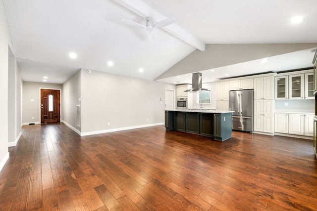 kitchen with dark wood finished floors, light countertops, appliances with stainless steel finishes, open floor plan, and island range hood