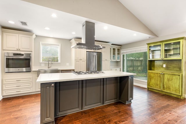 kitchen with lofted ceiling, a kitchen island, stainless steel appliances, dark hardwood / wood-style floors, and island exhaust hood