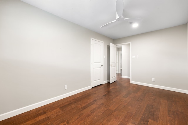 unfurnished bedroom with ceiling fan, dark wood finished floors, and baseboards