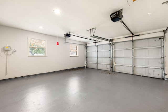 garage with a garage door opener and baseboards