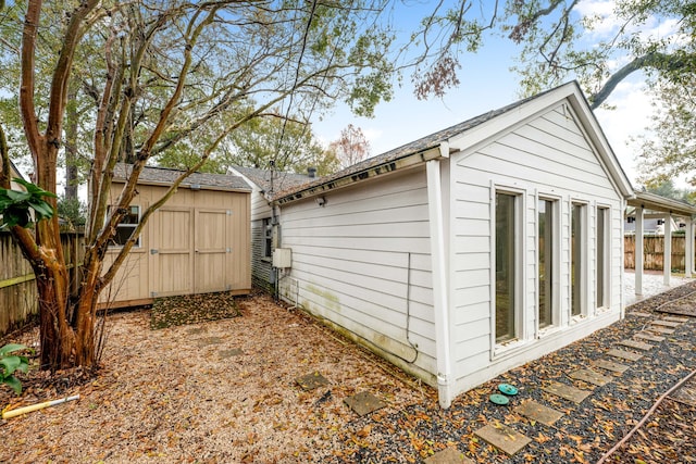 view of shed featuring fence