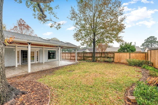 view of yard featuring a patio area and a fenced backyard