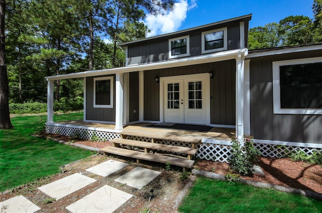 view of front of property with french doors and a front yard