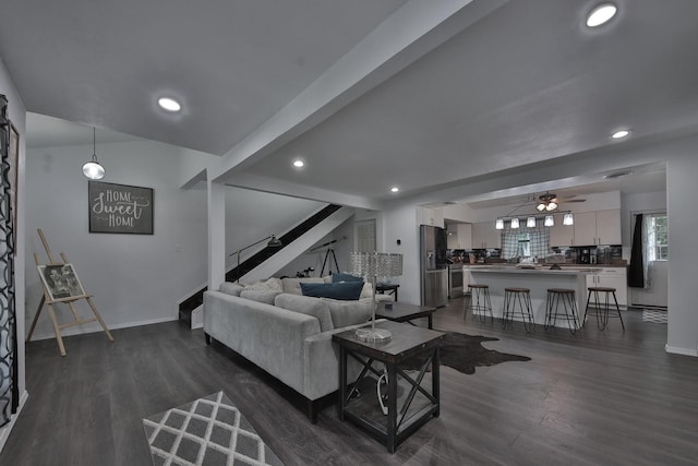 living room featuring ceiling fan and dark hardwood / wood-style flooring