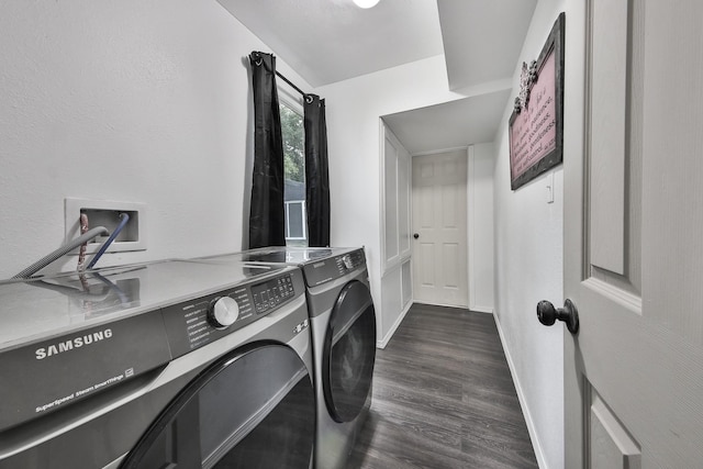 laundry room featuring dark hardwood / wood-style flooring and washer and dryer