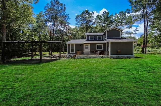 back of property with a carport, covered porch, and a lawn