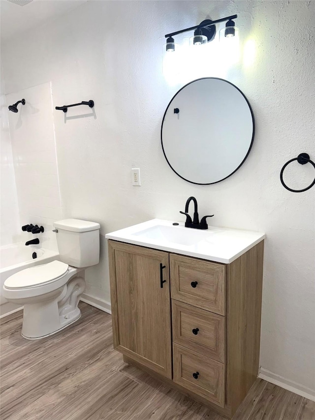 full bathroom with hardwood / wood-style flooring, vanity, toilet, and shower / bathing tub combination