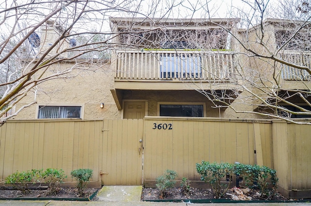 exterior space featuring a balcony and stucco siding